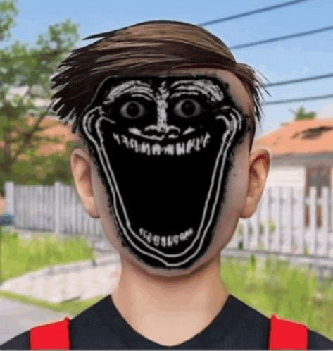 a boy with a troll face painted on his face is standing in front of a house .