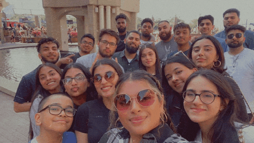 a group of people posing for a picture with one wearing sunglasses and a shirt that says calvin klein