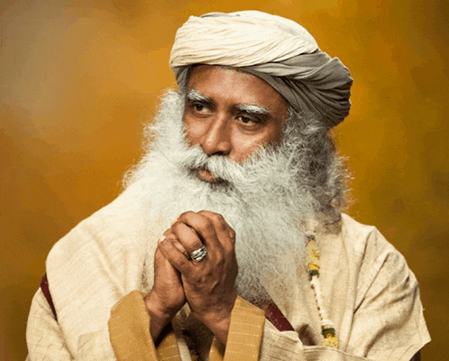 a man with a beard and a turban has his hands folded