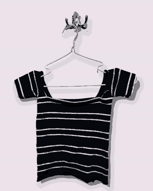 a black and white striped off the shoulder top is hanging on a hook