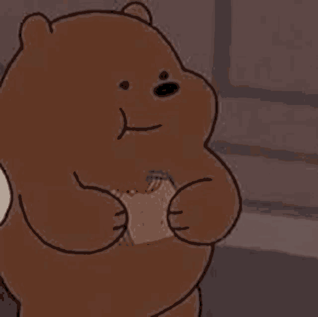 a brown bear from we bare bears is holding a piece of bread in his hands .