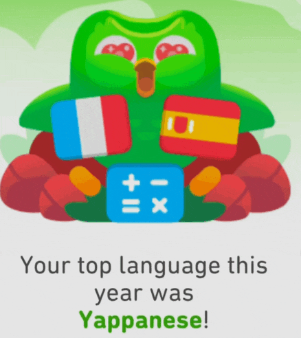 a green owl is holding a calculator with the words " your top language this year was yapponese " below it