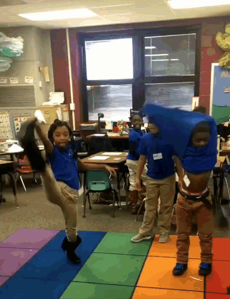 a group of children are dancing in a classroom with one wearing a name tag that says ' amanda ' on it