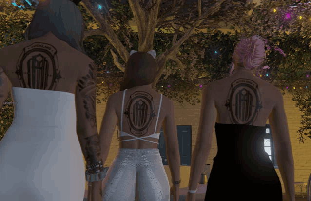 three women with tattoos on their backs including one that says auckland on it