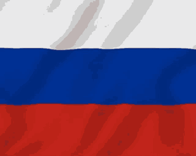 a close up of the russian flag waving in the wind .