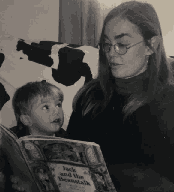 a woman reading jack and the beanstalk to a child