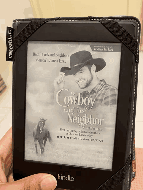 a person is holding a kindle with a book called a cowboy and his neighbor on it