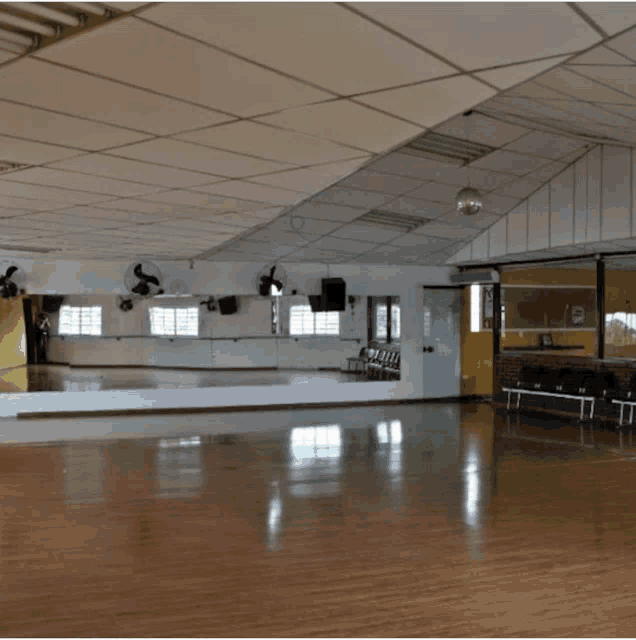 a large empty dance studio with a large mirror