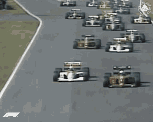 a blurred image of a race track with the letters f1 on the bottom right