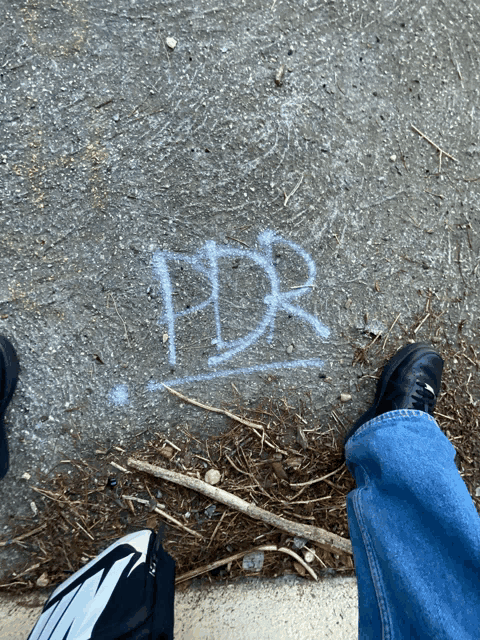 the word pdr is written in white chalk