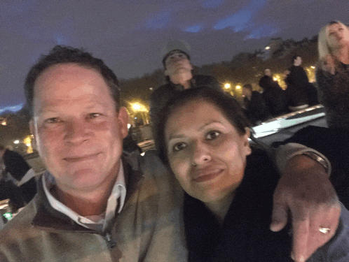 a man and woman are posing for a picture together