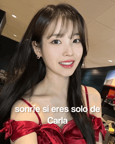 a woman in a red dress with the words sonrie si eres solo de carla