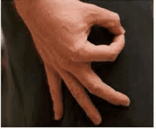 a close up of a person 's hand making a ok sign with their fingers .