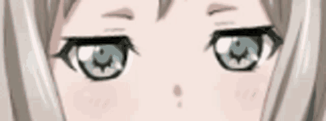 a close up of a anime girl 's eyes with a slight smile on her face .