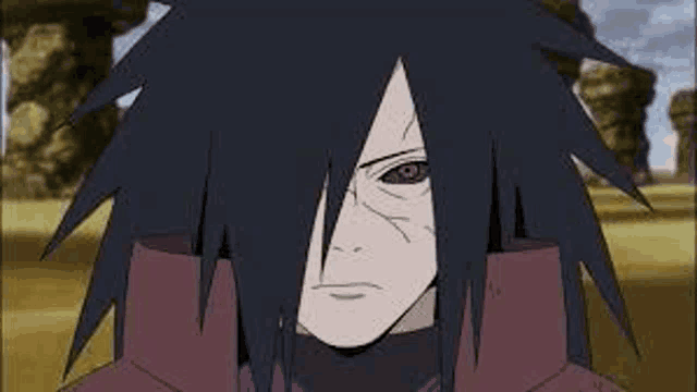 a close up of a naruto character 's face with a red eye and a black hair .