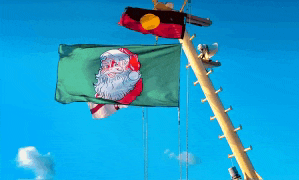 a green flag with santa claus on it is hanging from a pole