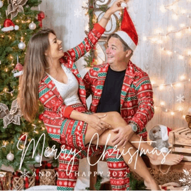 a merry christmas card with a man and woman