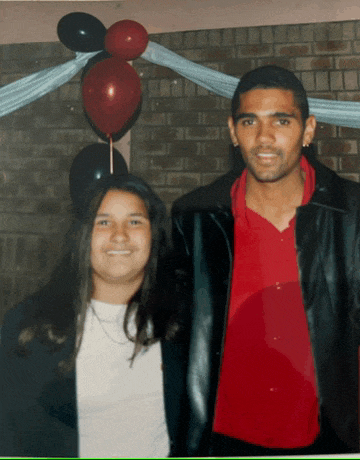 a man and a woman are posing for a picture in front of balloons