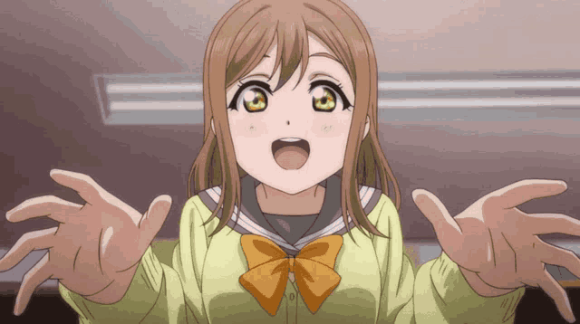 a girl in a yellow shirt with a bow on her bowtie is reaching out her hands