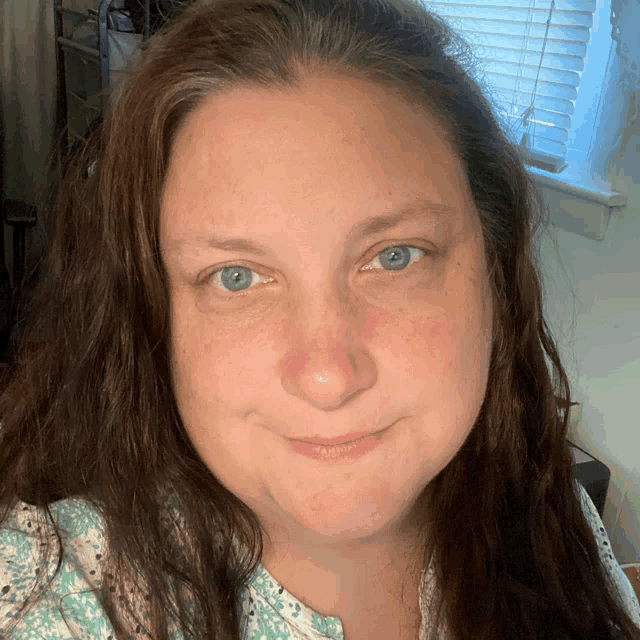 a close up of a woman 's face with blue eyes