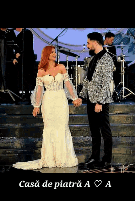 a woman in a wedding dress stands next to a man in a suit on a stage with the words casa de piatra a a