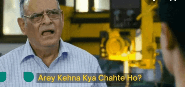 a man with glasses is talking to a woman with the words arey kehna kya chahte ho