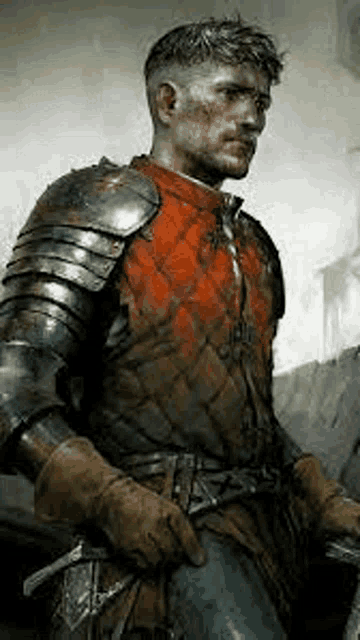 a man in armor is holding a sword and wearing a red vest .