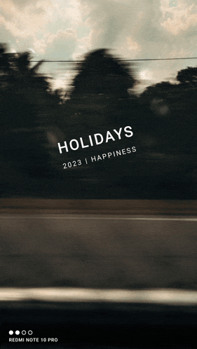 a blurred image of a road with the words holidays 2023 happiness written on it