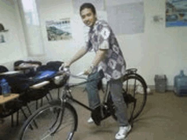 a man is riding a bicycle in a classroom