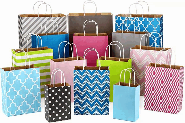 a bunch of different colored bags with handles on a white background