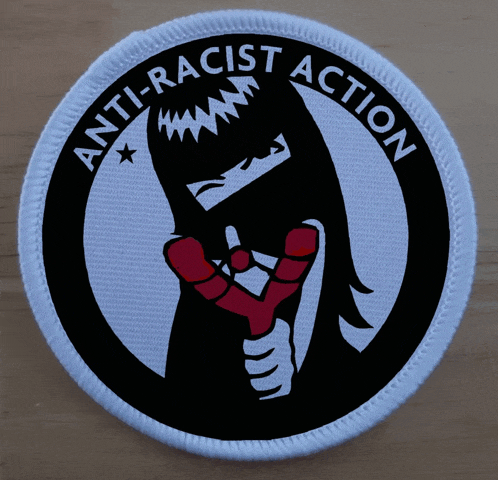 a round patch that says anti-racist action on it