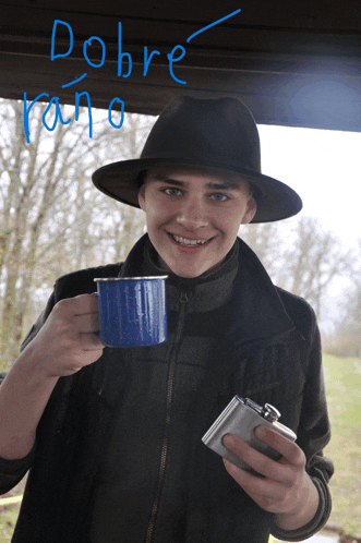 a man in a hat is holding a blue mug and a flask and the word dobre is written in blue