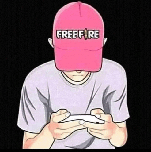 a man wearing a pink hat with the word free fire on it is playing a game on his phone .