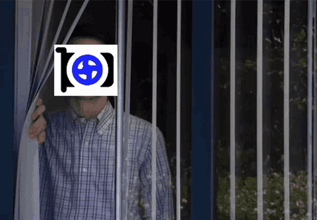 a man in a plaid shirt is behind bars with a blue and white logo on his face that says [ e ]