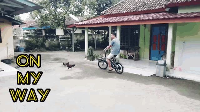 a man riding a bike in front of a house with the words " on my way " on the bottom