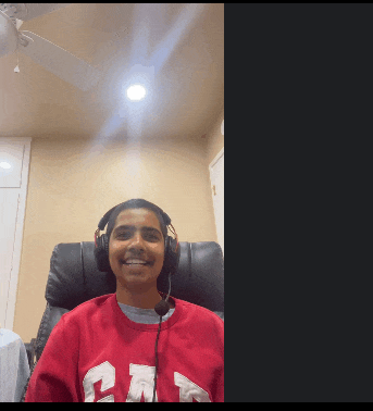 a woman wearing headphones and a red sweater with the letter n on it