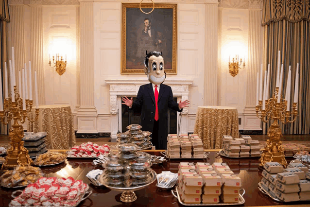 a man in a devil costume stands in front of a table full of food