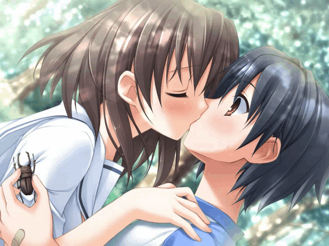 a boy and a girl are kissing and the girl is holding a bug in her hand