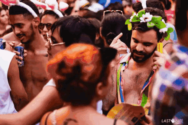 a crowd of people are gathered at a carnival and the word last is on the bottom of the image