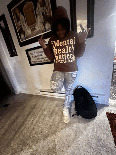 a person wearing a brown mental health matters hoodie