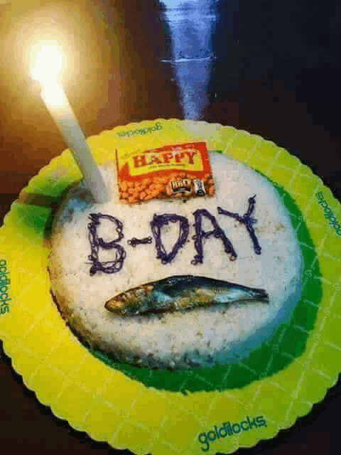 a b-day cake with a candle and a bag of happy