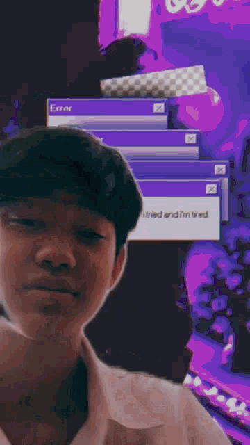 a boy is standing in front of a computer screen that says error i tried and i 'm tired