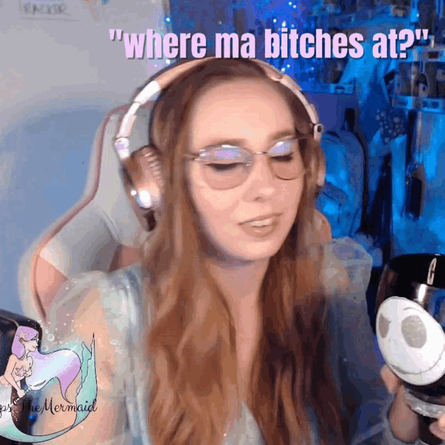 a woman wearing headphones says " where ma bitches at " while holding a cup