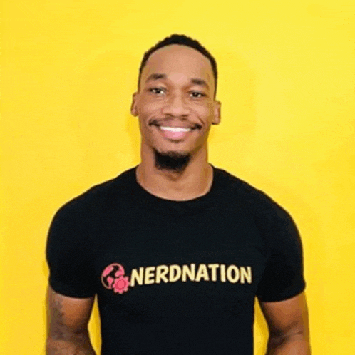 a man is wearing a black t-shirt with the word nerdnation on it and smiling .