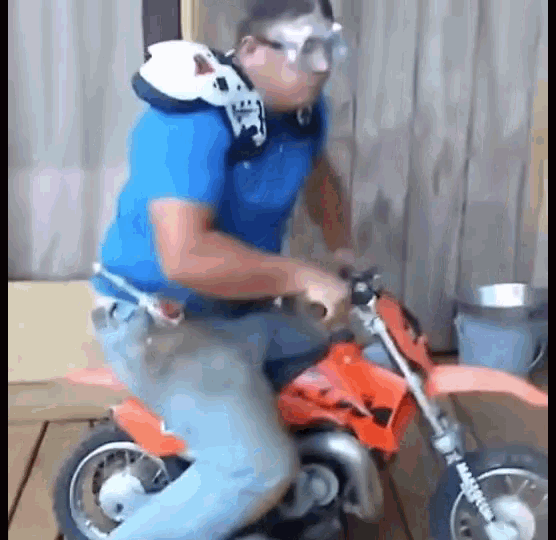 a man wearing a helmet and goggles is riding a small dirt bike .