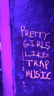 a neon sign that says pretty girls like trap music on it