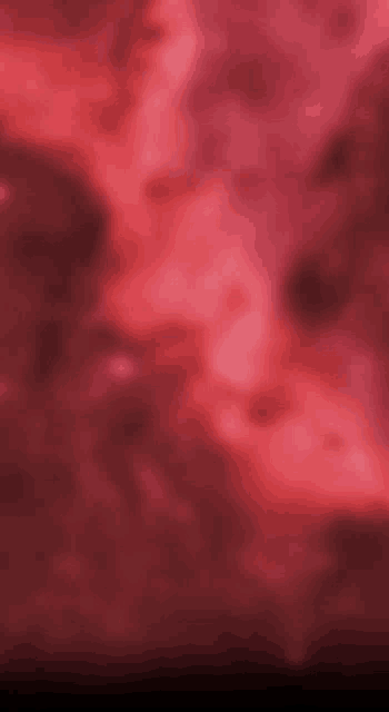 a blurred image of a red background with a few clouds in it