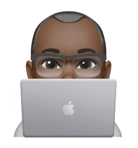 a man wearing glasses is peeking over an apple laptop