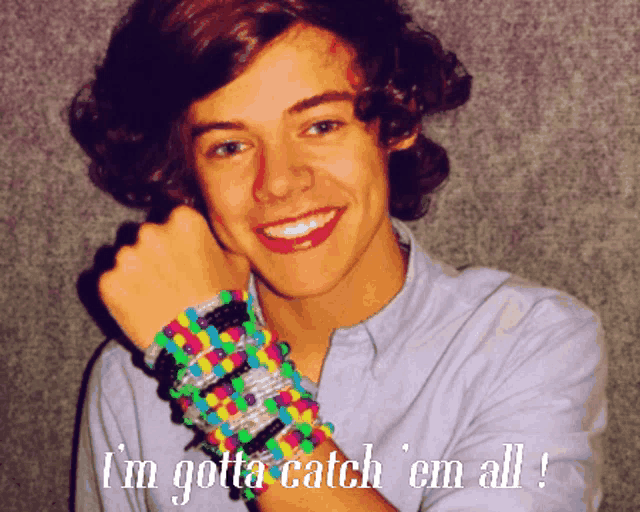 a young man with a bunch of bracelets on his wrist and the words i 'm gotta catch ' em all