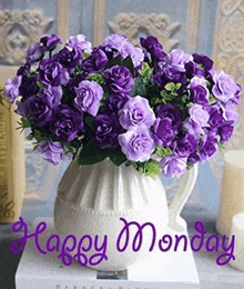 a vase filled with purple flowers with the words happy monday on it